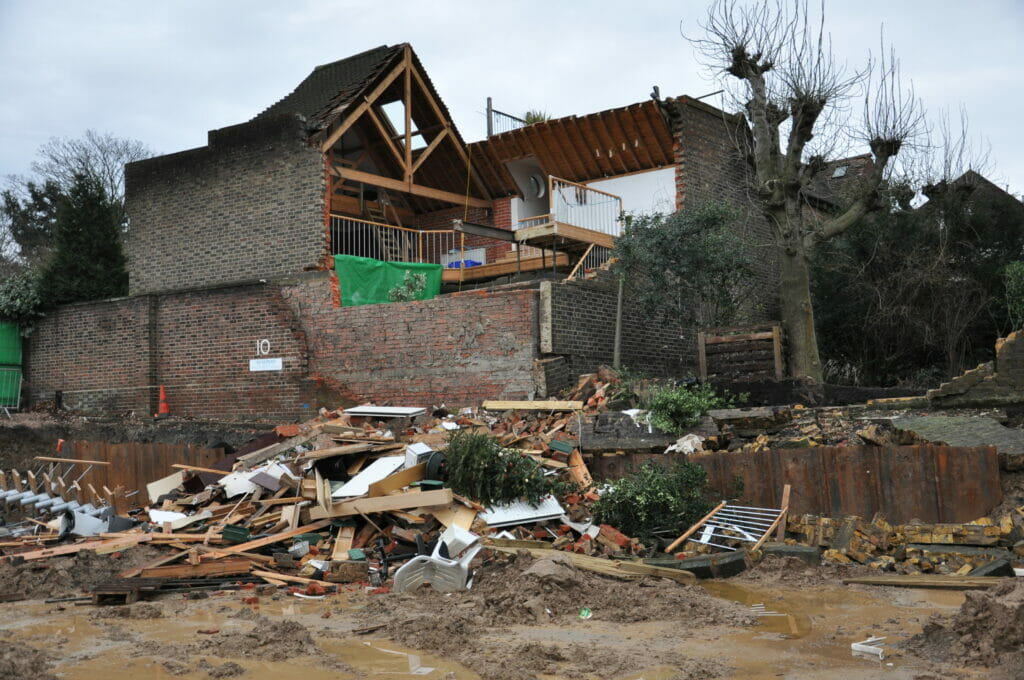 Figure 1: The sheet pile wall in the foreground with the damaged house behind.