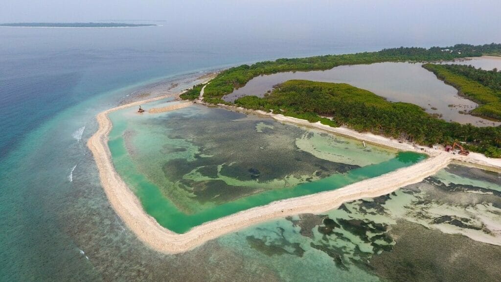 Aerial shot Image showing The Maldives Transport and Contracting Company building a Bund Wall