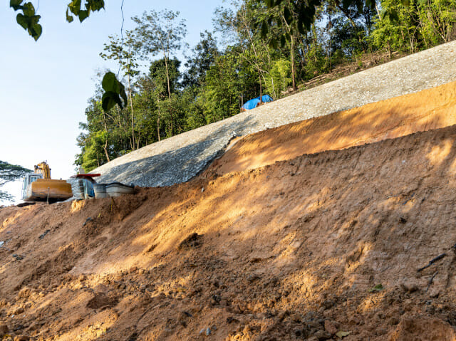 Slope retention construction work being carried out to manage landslide in highland