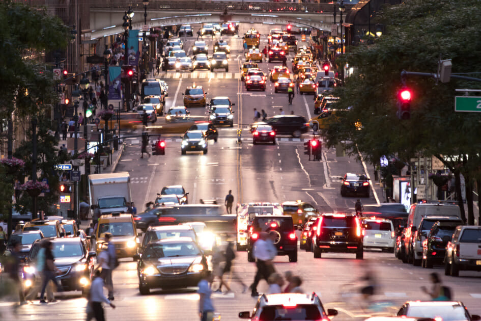 Busy evening cityscape with cars and people on 42nd Street in Midtown Manhattan New York City