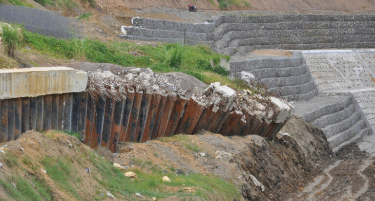 Ground subsidence and a small wall defence collapsing