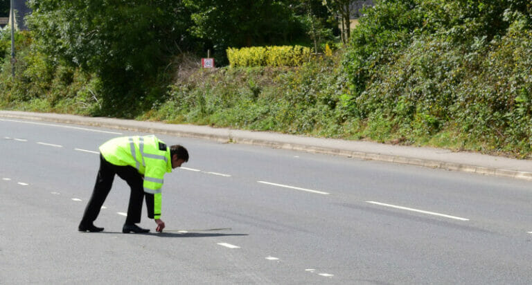 Man in the road with high visibility jacket on