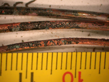 Arcing through char affecting two conductors over a length of 14mm. The scale in the image is in mm.