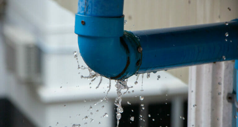 Closeup view of leaked and splash water from the plastic pipe du