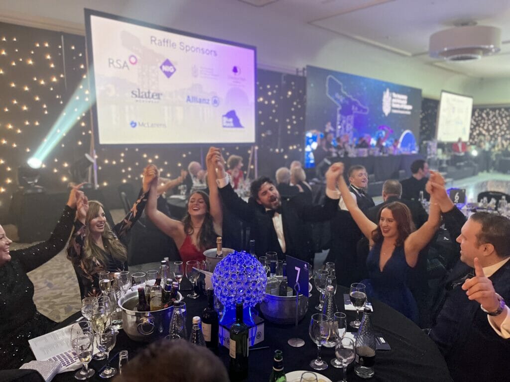 Glasgow Regional Manager John Holland (centre) celebrates with clients at the Insurance and Actuarial Society of Glasgow annual dinner