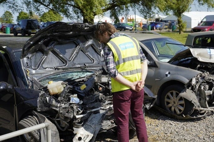 Hawkins inspecting damaged vehicle 1