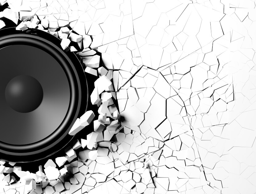 Loudspeaker on a cracked white wall