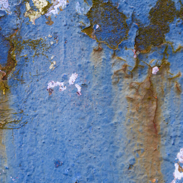 Blue paint cracking and blistering on rusty steel surface