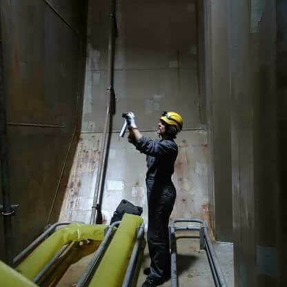 Hawkins Investigator taking photos inside the lining of a ship tank