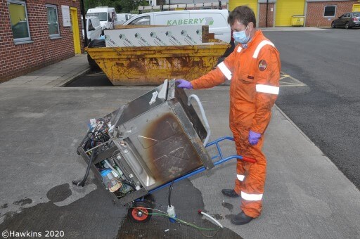 Paul Gee onsite assessing a fire damaged appliance