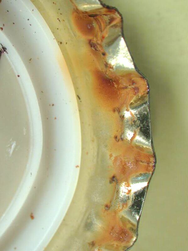 View from under the cap of a corroded metal bottle top