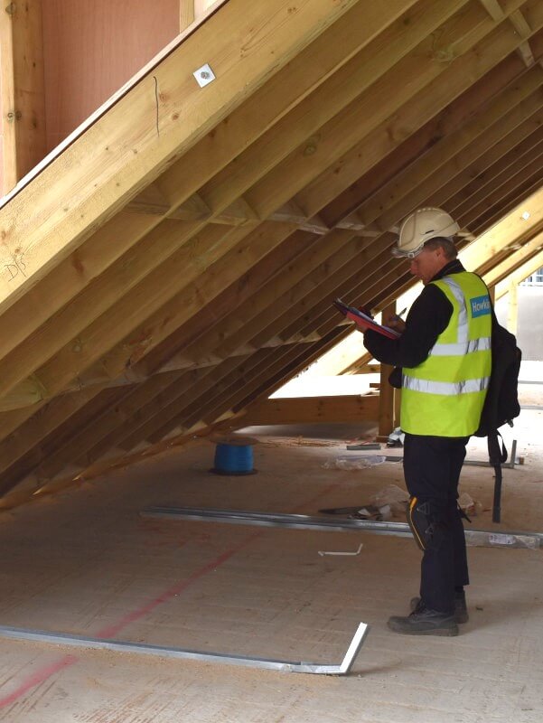 Hawkins investigator inspecting timber truss roof