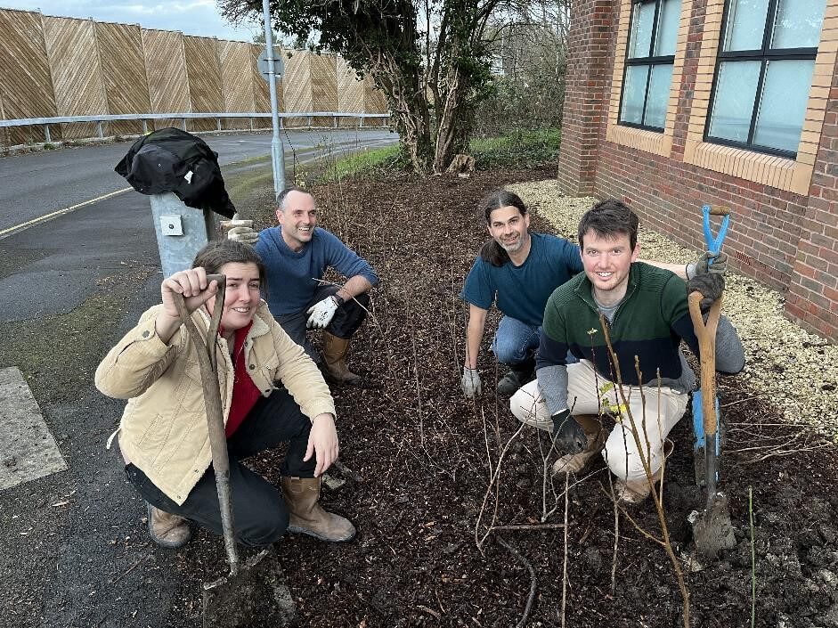 Image of Hawkins Investigators planting shrubbery at the Bristol office