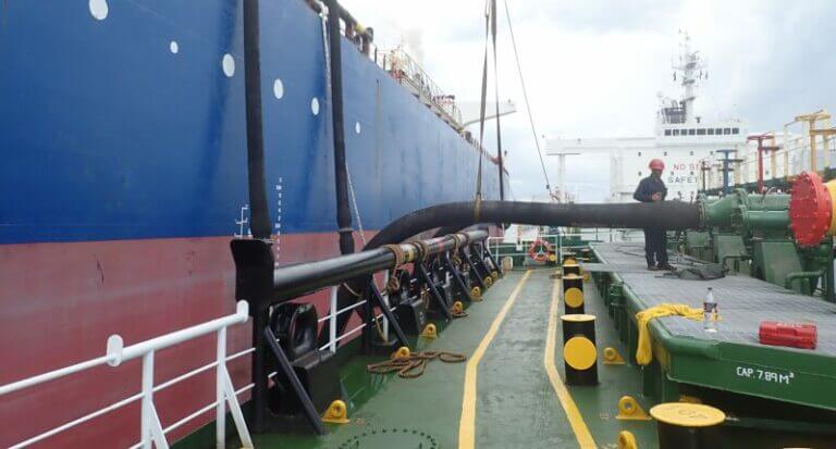 Photo of a Ship to Ship Transfer (STS) via large pipes underway