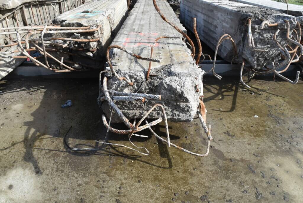 Image of concrete column with mangled piping