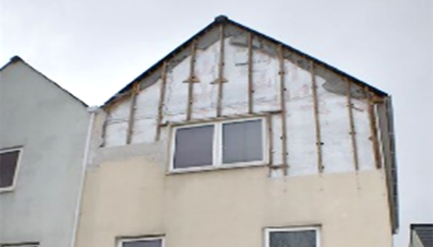 Cladding boards blown from the face of a white house