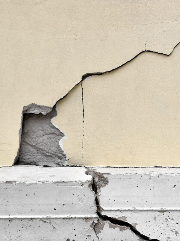 Plaster falling off a wall - on a cracked building - following an earthhquake