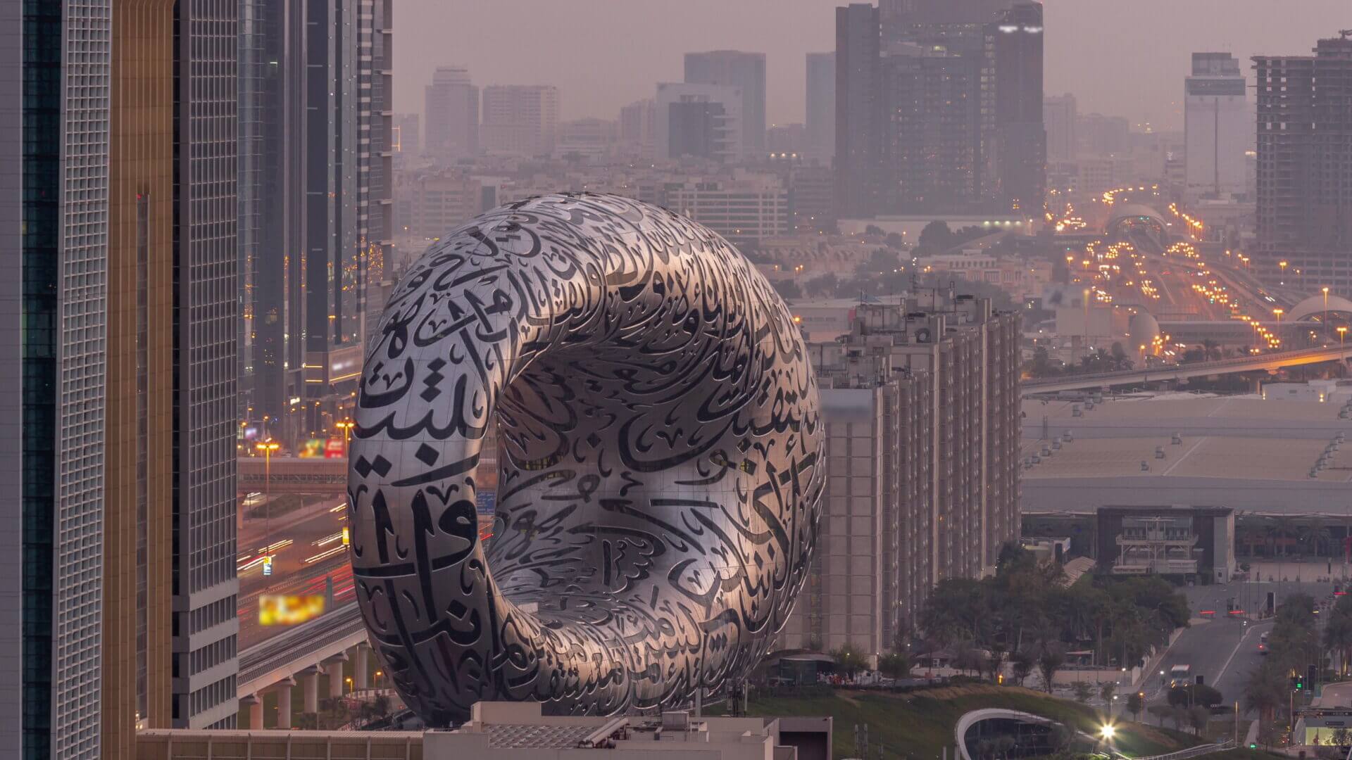 Museum of the Future exhibition space aerial night to day timelapse with iconic torus shape