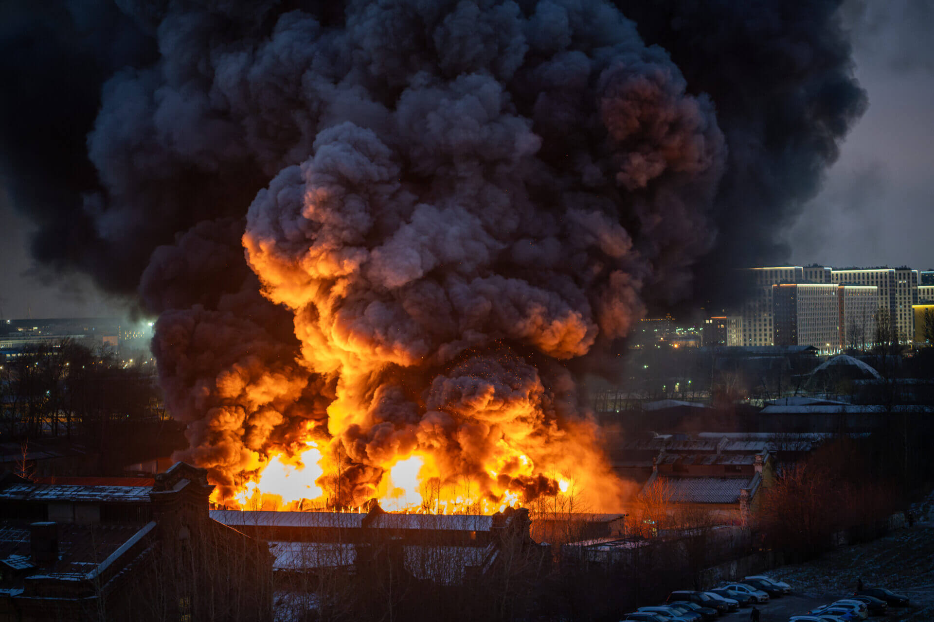 Heavy fire with acrid smoke in warehouse with toxic paint materials. Industrial fire, air pollution.